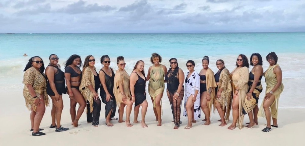 Wholelistic women on a white-sand beach during a retreat
