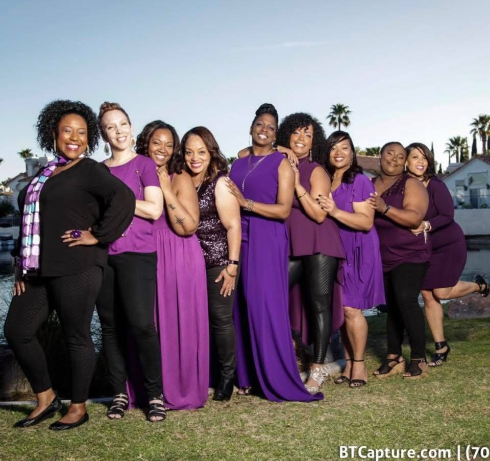 Wholelistic women in purple and black, arm in arm by the water in Las Vegas