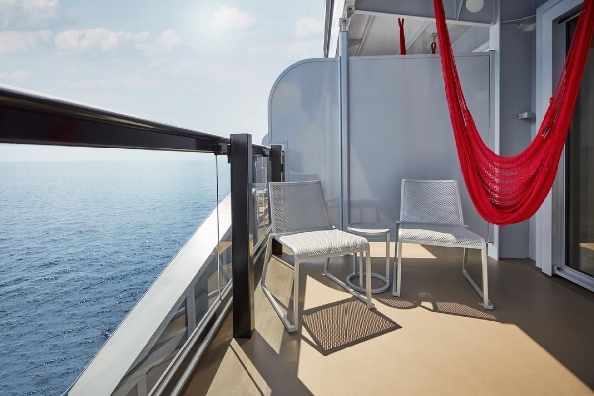 Sea Terrace balcony with a red hammock over the sea